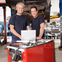 Mechanics with Laptop in Auto Repair Shop